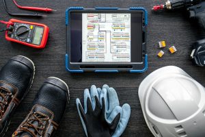 Composition with digital tablet and electrician work items.